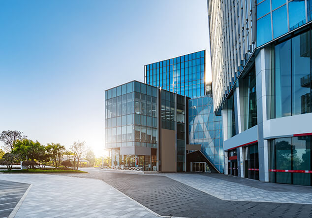 Exterior of a modern office with the sun rising in the background