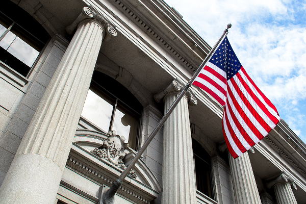Government building with American flag above doorway
