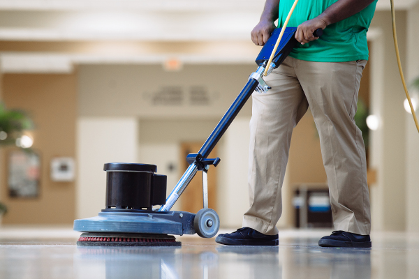 Janitor cleaning business building floor