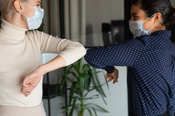 social distancing handshake by tapping elbows