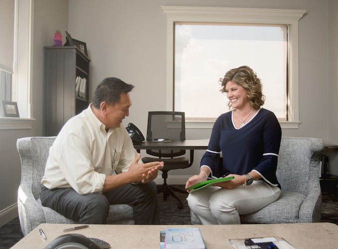 business owner talking to client in clean office