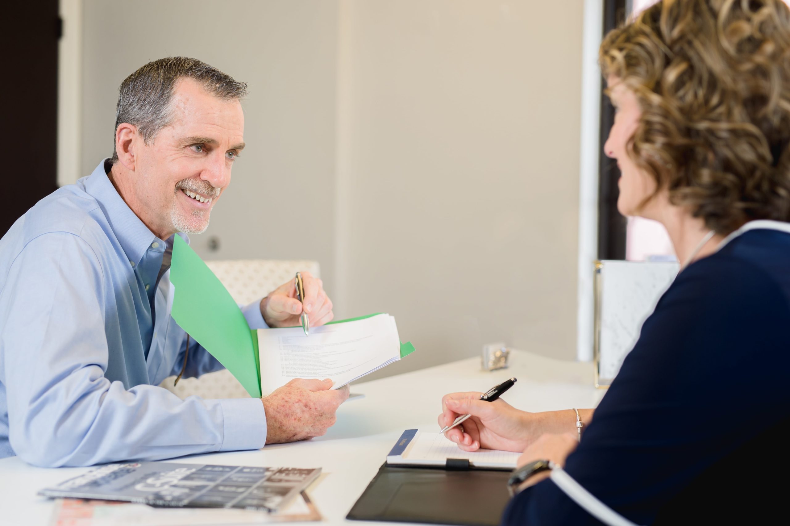 Two happy people going over commercial cleaning agreement