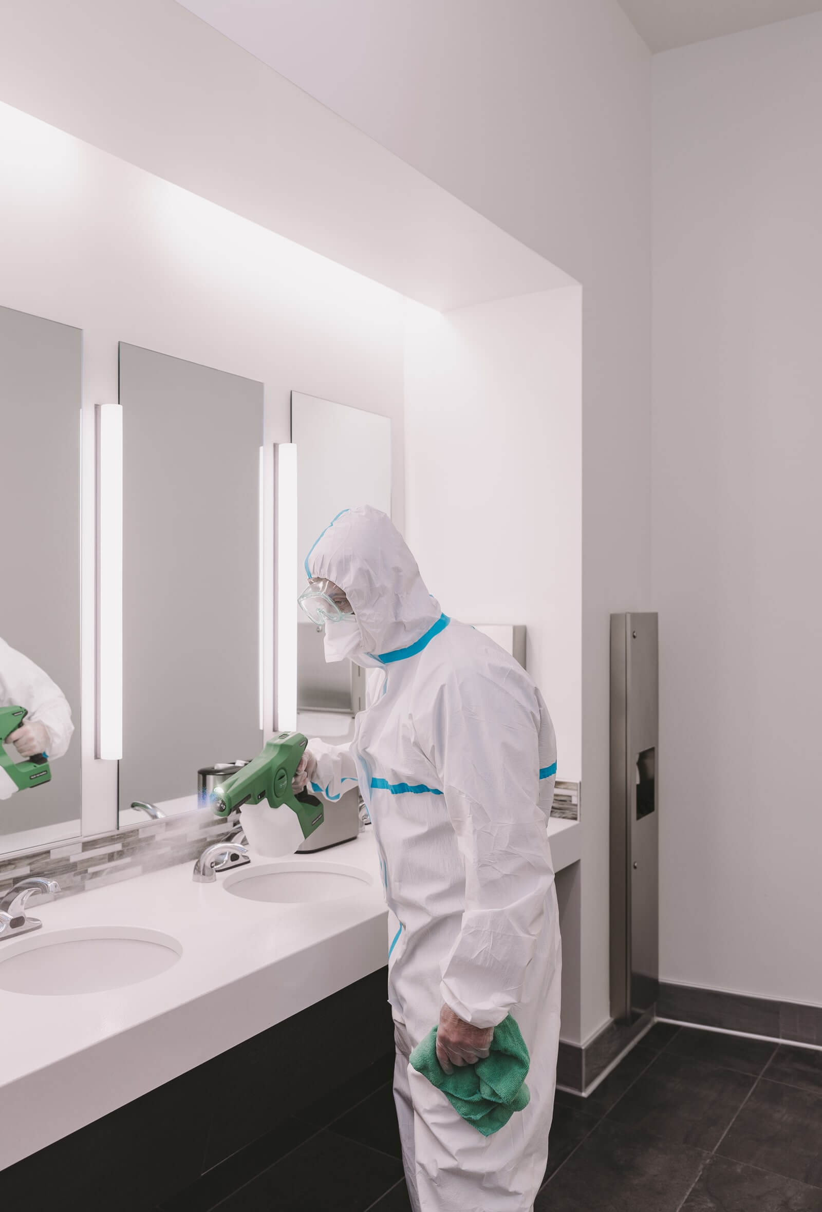 Commercial cleaning employee cleaning office bathroom