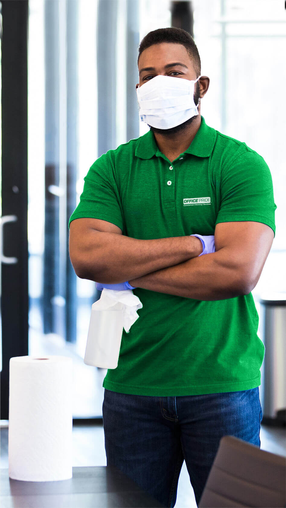 janitor posing with bottle and paper towels
