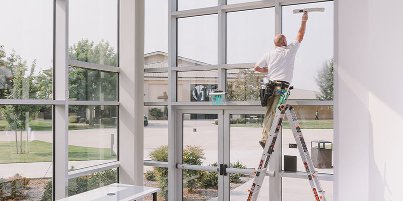 Office cleaning professional cleaning window above entrance doors